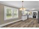Kitchen and dining area featuring hardwood floors, stainless steel appliances, and white cabinets at 105 N Baldwin Ave, Kannapolis, NC 28083