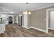 Kitchen and dining area featuring hardwood floors, stainless steel appliances, and white trim at 105 N Baldwin Ave, Kannapolis, NC 28083