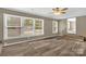 Spacious living area boasting large windows, ceiling fan, and updated wood floors at 105 N Baldwin Ave, Kannapolis, NC 28083
