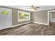 Open living room with a large window that brings in natural light and beautiful new floors at 105 N Baldwin Ave, Kannapolis, NC 28083