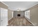 Inviting living room with new floors, gray brick fireplace, and plenty of natural light at 105 N Baldwin Ave, Kannapolis, NC 28083