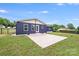 Exterior view of backyard featuring blue vinyl siding, a concrete patio, and a partial view of fencing at 11 Cobblestone Nw Ln, Concord, NC 28027