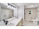 Modern bathroom featuring double sinks, quartz countertop, sleek black fixtures, and well lit mirror at 11 Cobblestone Nw Ln, Concord, NC 28027