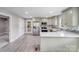 Well-lit kitchen with stainless steel appliances, open layout, and backyard access at 11 Cobblestone Nw Ln, Concord, NC 28027