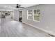 Spacious open-concept living space with light grey floors, bright natural light, and kitchen view at 11 Cobblestone Nw Ln, Concord, NC 28027