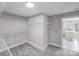 Walk-in closet with wall-mounted wire shelving system, neutral walls, and plush gray carpet at 11 Cobblestone Nw Ln, Concord, NC 28027