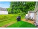Expansive backyard featuring a patio, grill, and well-manicured lawn for outdoor enjoyment at 117 S Canyon Ridge S Dr, Mount Holly, NC 28120