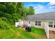 Lush backyard with a cozy patio area perfect for outdoor entertaining with green trees at 117 S Canyon Ridge S Dr, Mount Holly, NC 28120