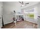 Bedroom with wood-look floors, white bunk bed, large window, and white curtains at 117 S Canyon Ridge S Dr, Mount Holly, NC 28120