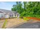Charming single-story home features a well-kept lawn and convenient parking area at 117 S Canyon Ridge S Dr, Mount Holly, NC 28120