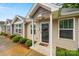 Inviting home exterior with detailed trim, a covered entry, and neat landscaping at 117 S Canyon Ridge S Dr, Mount Holly, NC 28120