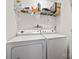 Clean laundry room featuring a stacked washer and dryer with a shelf above for storage at 117 S Canyon Ridge S Dr, Mount Holly, NC 28120