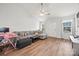 Comfortable living room features a gray sectional sofa, wood-look floors, and a ceiling fan at 117 S Canyon Ridge S Dr, Mount Holly, NC 28120