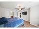 Spacious main bedroom features wood-look floors, a ceiling fan, and an en-suite bathroom at 117 S Canyon Ridge S Dr, Mount Holly, NC 28120