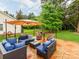 Back patio area, with a conversation set, a grill, and a view of the fenced yard at 11719 Withers Mill Dr, Charlotte, NC 28278