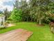 Expansive backyard featuring a wooden deck, a well-maintained lawn, and mature trees for privacy at 11719 Withers Mill Dr, Charlotte, NC 28278