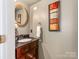 Charming half bathroom with ornate mirror and sink at 11719 Withers Mill Dr, Charlotte, NC 28278