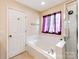 Relaxing bathroom featuring a soaking tub and separate shower, providing a spa-like experience at home at 11719 Withers Mill Dr, Charlotte, NC 28278