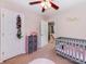 Bright Bedroom featuring pink accents, a comfortable crib, and a charming closet for a delightful space at 11719 Withers Mill Dr, Charlotte, NC 28278
