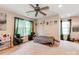 Versatile bedroom with unique artwork, ample natural light, and a large ceiling fan for modern living at 11719 Withers Mill Dr, Charlotte, NC 28278