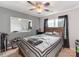 Well-lit bedroom with a large mirror, rustic wooden bed frame, and a ceiling fan for added comfort at 11719 Withers Mill Dr, Charlotte, NC 28278