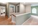 Upstairs hallway that features three doorways and neutral wall colors at 11719 Withers Mill Dr, Charlotte, NC 28278