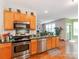 A kitchen with stainless steel appliances, wood cabinets, and an open concept at 11719 Withers Mill Dr, Charlotte, NC 28278