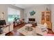 Cozy living room featuring light-filled windows, wood flooring, and comfortable seating with modern decor at 11719 Withers Mill Dr, Charlotte, NC 28278