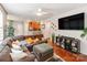 Spacious living room features an open layout, hardwood floors, a large sectional sofa, and a television at 11719 Withers Mill Dr, Charlotte, NC 28278