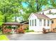 Backyard with a gazebo, lush garden, and a sunroom extension on the house, ideal for outdoor living at 1287 Queensgate St, Gastonia, NC 28054