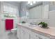 Clean bathroom with white tile, pink countertop and plants, offering a refreshing space at 1287 Queensgate St, Gastonia, NC 28054
