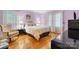 Bedroom with hardwood floors, a plush bed, and soft, neutral lighting, creating a serene atmosphere at 1287 Queensgate St, Gastonia, NC 28054