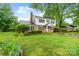 Charming two-story home with a well-manicured lawn, brick accents, and lush greenery at 1287 Queensgate St, Gastonia, NC 28054