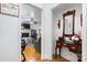 Cozy hallway leading to the living room with hardwood floors and classic decor with fireplace and brick surround at 1287 Queensgate St, Gastonia, NC 28054