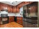 Modern kitchen with stainless steel appliances, wood cabinets, and ample counter space at 1287 Queensgate St, Gastonia, NC 28054