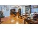 Inviting living room featuring hardwood floors, comfortable seating, and a vintage display cabinet at 1287 Queensgate St, Gastonia, NC 28054