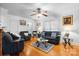 Bright living room with ceiling fan, hardwood floors, and comfortable seating arrangement at 1287 Queensgate St, Gastonia, NC 28054