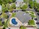 Overhead view of community pool surrounded by trees, with homes and roadways visible at 13216 Old Compton Ct, Pineville, NC 28134