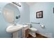 Powder room featuring blue walls, and a pedestal sink at 13216 Old Compton Ct, Pineville, NC 28134