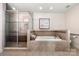 Bathroom with a glass-enclosed shower and soaking tub at 13216 Old Compton Ct, Pineville, NC 28134