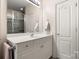 Bathroom featuring a vanity with white cabinets and a large mirror at 13216 Old Compton Ct, Pineville, NC 28134