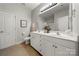 Bright bathroom with dual sinks, a large mirror, and plenty of counter space at 13216 Old Compton Ct, Pineville, NC 28134