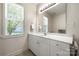 Bathroom featuring a vanity with white cabinets and a window at 13216 Old Compton Ct, Pineville, NC 28134
