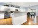 Spacious kitchen featuring an island with seating, white cabinetry, and stainless steel appliances at 13216 Old Compton Ct, Pineville, NC 28134