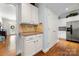 Hallway with white cabinets and stainless steel refrigerator at 13216 Old Compton Ct, Pineville, NC 28134