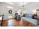 Bright living room featuring hardwood floors, a seating area, a patterned rug, and natural light at 13216 Old Compton Ct, Pineville, NC 28134