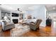 Bright living room featuring a fireplace, built-in shelving, and neutral furnishings at 13216 Old Compton Ct, Pineville, NC 28134