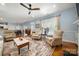 Open living area with hardwood floors, large windows, and a view of the dining room at 13216 Old Compton Ct, Pineville, NC 28134