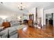 Spacious living room featuring hardwood floors, a comfortable seating area, and a staircase at 13216 Old Compton Ct, Pineville, NC 28134