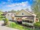Aerial view of a home showcasing a well-maintained lawn, a screened porch, and mature trees at 13216 Old Compton Ct, Pineville, NC 28134